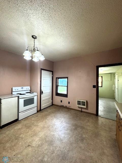 857 Main St, Mahnomen, MN 56557 - kitchen featuring white electric stove, a chandelier, a textured ceiling, decorative light fixtures, and light countertops