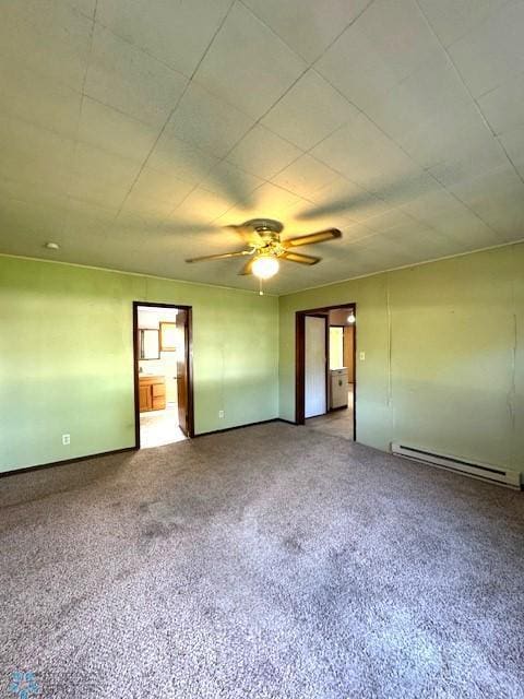 857 Main St, Mahnomen, MN 56557 - empty room featuring a baseboard heating unit, ceiling fan, and carpet