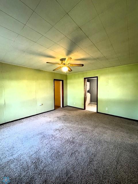 857 Main St, Mahnomen, MN 56557 - empty room featuring carpet and a ceiling fan