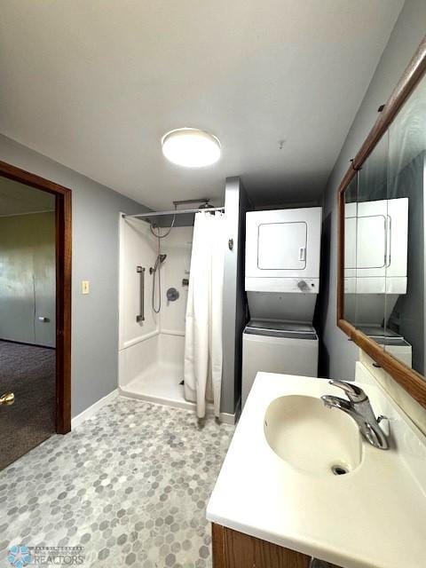 857 Main St, Mahnomen, MN 56557 - full bath with stacked washing machine and dryer, vanity, and curtained shower