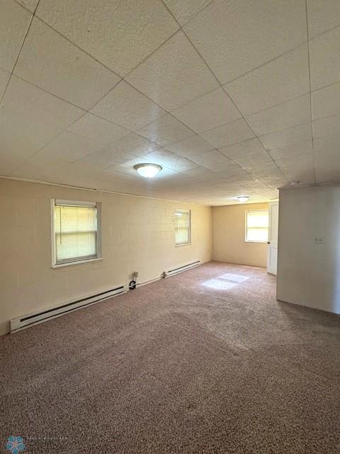 857 Main St, Mahnomen, MN 56557 - carpeted spare room with a baseboard heating unit