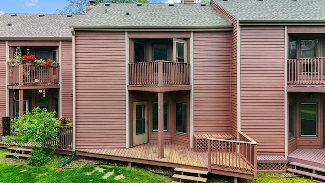 1369 Spencer Rd W, Saint Paul, MN 55108 - back of house featuring a chimney and roof with shingles