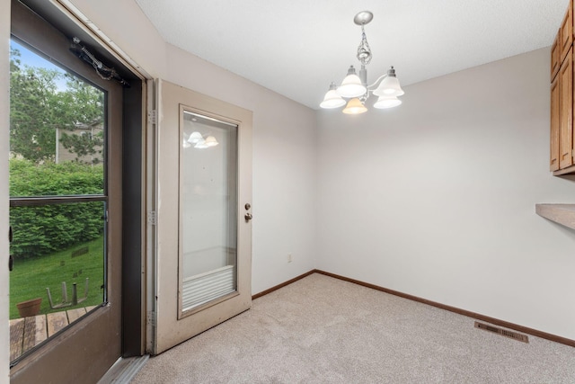 1369 Spencer Rd W, Saint Paul, MN 55108 - unfurnished room with light colored carpet and a chandelier