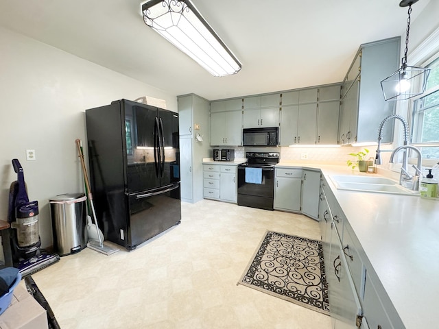 906 Whitford St, Fergus Falls, MN 56537 - kitchen with black appliances, gray cabinetry, light floors, light countertops, and decorative light fixtures