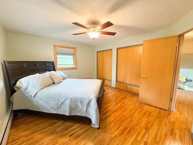 906 Whitford St, Fergus Falls, MN 56537 - bedroom with light wood-type flooring, two closets, a ceiling fan, and baseboard heating