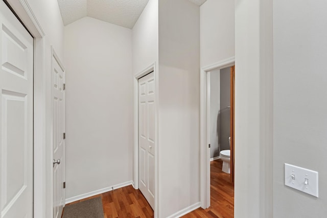 5900 Oxford St Unit 8, Saint Louis Park, MN 55416 - hallway featuring wood finished floors, vaulted ceiling, and a textured ceiling