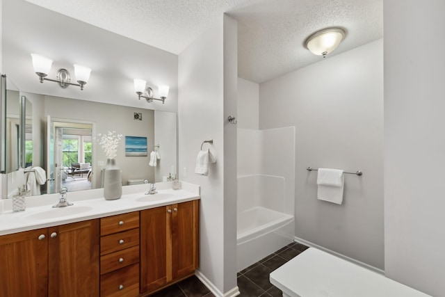 5900 Oxford St Unit 8, Saint Louis Park, MN 55416 - bathroom featuring double vanity, a textured ceiling, tile patterned floors, and  shower combination