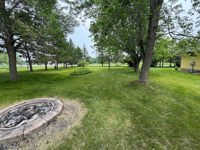 106 Oak Ave, Ottertail, MN 56571 - view of grassy yard featuring a fire pit