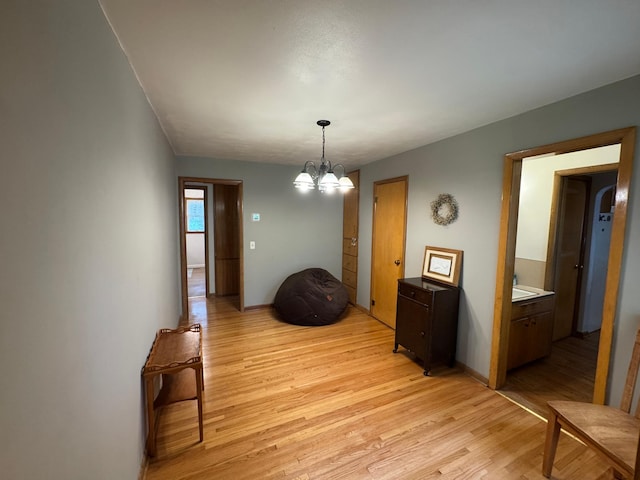 106 Oak Ave, Ottertail, MN 56571 - hallway with light wood-style flooring and a chandelier