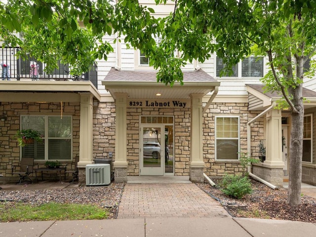 8292 Labont Way Unit 210, Eden Prairie, MN 55344 - property entrance featuring stone siding, a balcony, and a porch