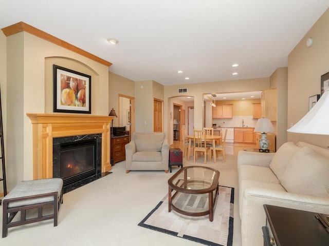 8292 Labont Way Unit 210, Eden Prairie, MN 55344 - living room featuring a high end fireplace, recessed lighting, and light colored carpet