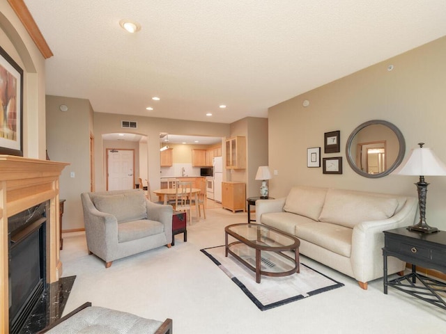 8292 Labont Way Unit 210, Eden Prairie, MN 55344 - living area featuring a high end fireplace, light carpet, recessed lighting, and arched walkways