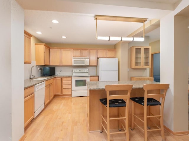 8292 Labont Way Unit 210, Eden Prairie, MN 55344 - kitchen featuring white appliances, light brown cabinets, light wood-type flooring, a kitchen breakfast bar, and recessed lighting