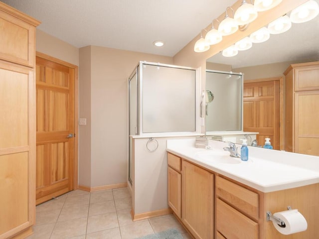 8292 Labont Way Unit 210, Eden Prairie, MN 55344 - bathroom featuring a stall shower, vanity, tile patterned flooring, and recessed lighting