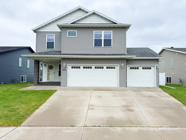 4551 15th St S, Moorhead, MN 56560 - view of front of house with a front yard, concrete driveway, and an attached garage
