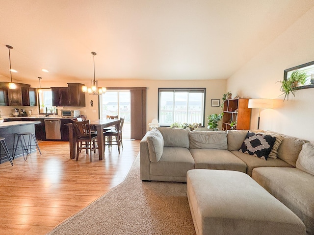 4551 15th St S, Moorhead, MN 56560 - living area with light wood finished floors, plenty of natural light, a chandelier, and lofted ceiling