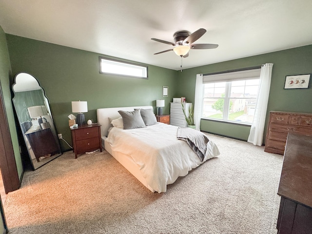4551 15th St S, Moorhead, MN 56560 - bedroom featuring multiple windows, light carpet, and a ceiling fan