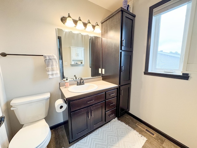 4551 15th St S, Moorhead, MN 56560 - bathroom featuring wood finished floors, vanity, and healthy amount of natural light