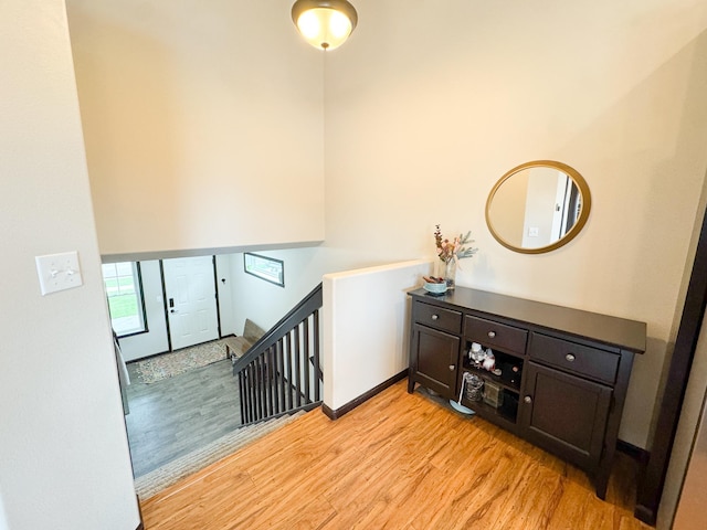 4551 15th St S, Moorhead, MN 56560 - hallway with light wood-style flooring, an upstairs landing, and a towering ceiling