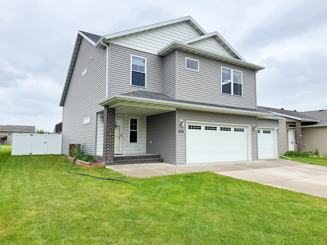4551 15th St S, Moorhead, MN 56560 - view of front facade featuring an attached garage, a gate, and concrete driveway