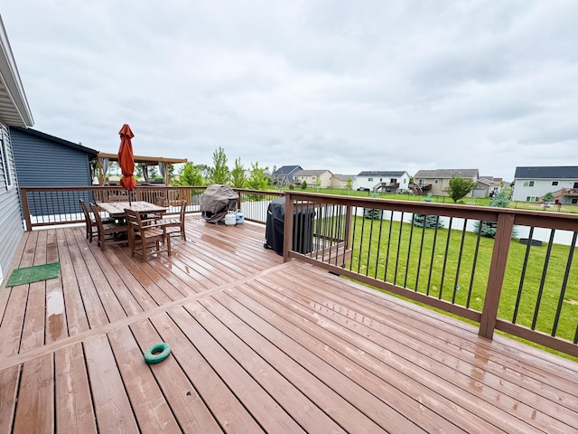 4551 15th St S, Moorhead, MN 56560 - deck featuring outdoor dining space, a residential view, a yard, and a grill