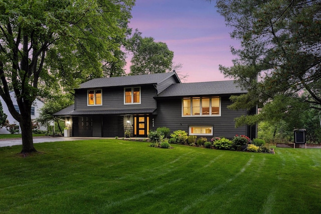 4428 Marlborough Ct, Minnetonka, MN 55345 - tri-level home featuring a garage, a front yard, concrete driveway, and covered porch