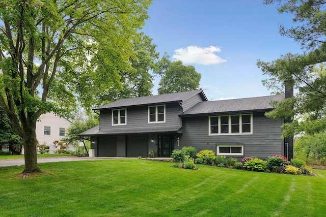4428 Marlborough Ct, Minnetonka, MN 55345 - tri-level home featuring a garage, a front lawn, and driveway