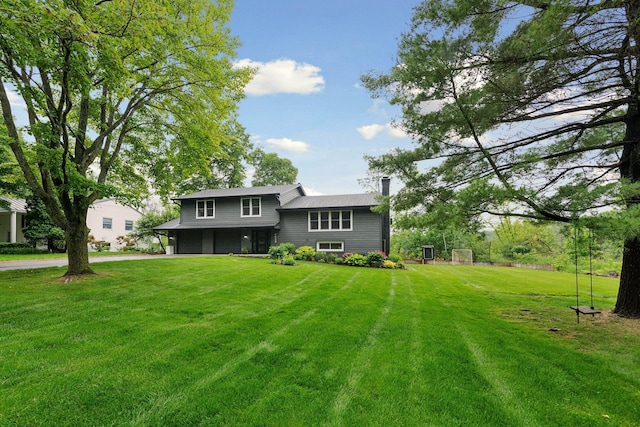 4428 Marlborough Ct, Minnetonka, MN 55345 - back of house with an attached garage, driveway, a chimney, and a yard