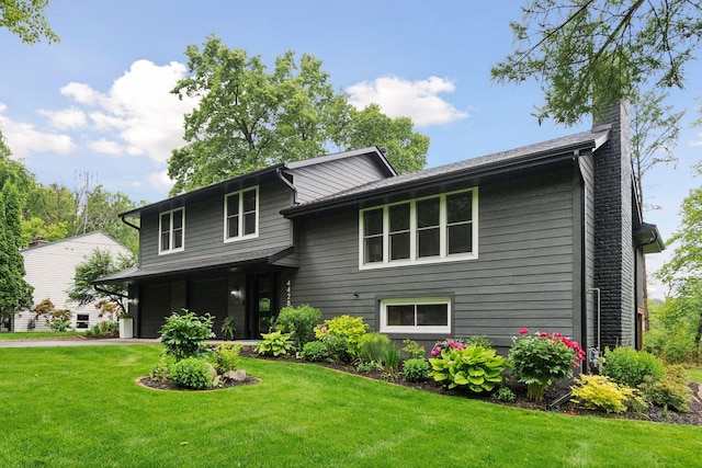 4428 Marlborough Ct, Minnetonka, MN 55345 - tri-level home with a front lawn, a chimney, a garage, and driveway