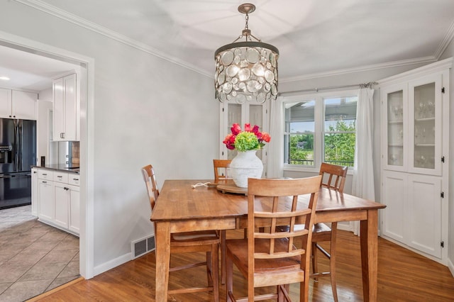 4428 Marlborough Ct, Minnetonka, MN 55345 - dining space with ornamental molding, a chandelier, and light wood-type flooring