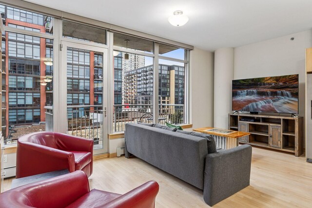 215 10th Ave S Unit 533, Minneapolis, MN 55415 - living area featuring wood finished floors and a baseboard heating unit