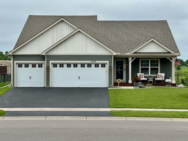 7559 Oday Ln NE, Otsego, MN 55330 - view of front of home with roof with shingles, driveway, covered porch, and an attached garage