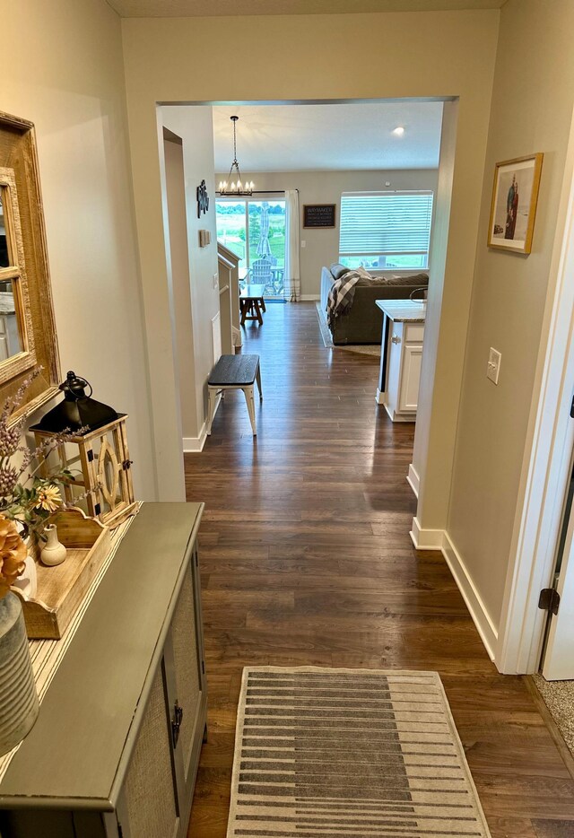 7559 Oday Ln NE, Otsego, MN 55330 - hallway featuring dark wood-style floors and a chandelier