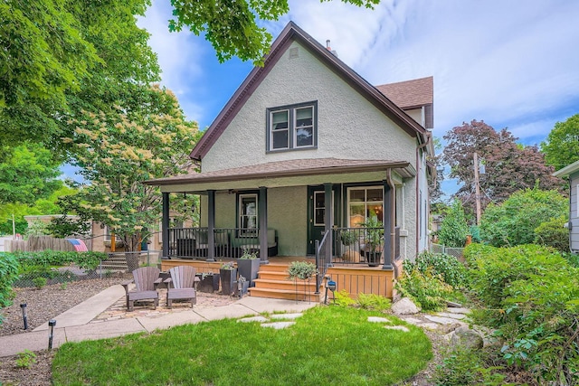 2707 Brighton Ave NE, Minneapolis, MN 55418 - back of property with covered porch, stucco siding, and a shingled roof