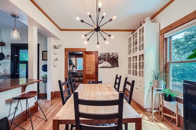 2707 Brighton Ave NE, Minneapolis, MN 55418 - dining space with a chandelier, light wood-style flooring, and crown molding