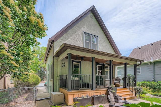 2707 Brighton Ave NE, Minneapolis, MN 55418 - view of front of house with covered porch, stucco siding, and a gate