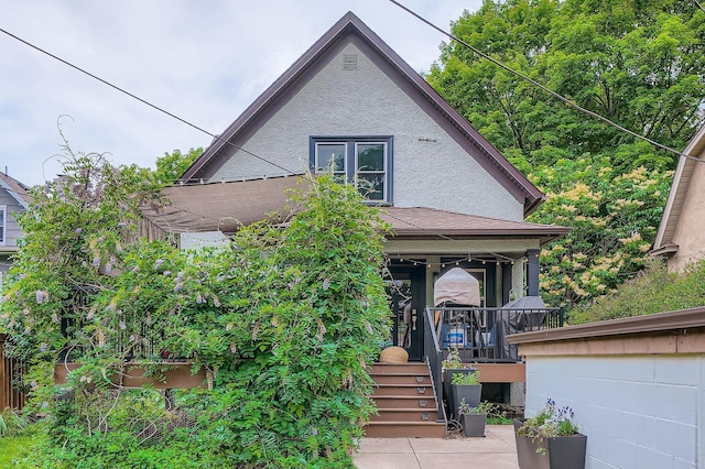 2707 Brighton Ave NE, Minneapolis, MN 55418 - view of front of home featuring covered porch and stucco siding