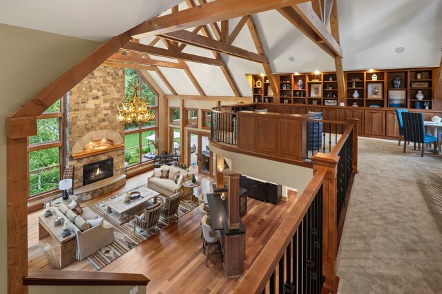 6445 County Road 26, Minnetrista, MN 55364 - living room with high vaulted ceiling, plenty of natural light, a chandelier, a fireplace, and beamed ceiling