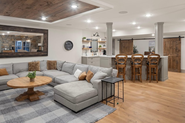 6445 County Road 26, Minnetrista, MN 55364 - living area with a barn door, ornate columns, light wood-type flooring, and recessed lighting