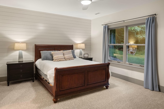 6445 County Road 26, Minnetrista, MN 55364 - bedroom featuring light carpet, a ceiling fan, and wooden walls