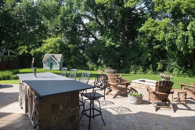 6445 County Road 26, Minnetrista, MN 55364 - view of patio with an outdoor fire pit, a storage shed, and view of scattered trees
