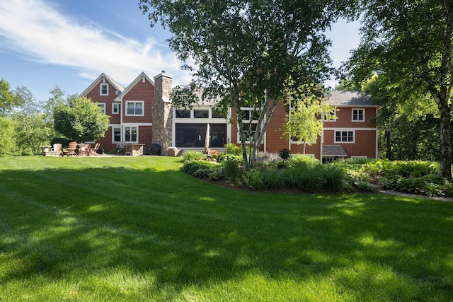 6445 County Road 26, Minnetrista, MN 55364 - back of property with a chimney, a yard, and a patio area
