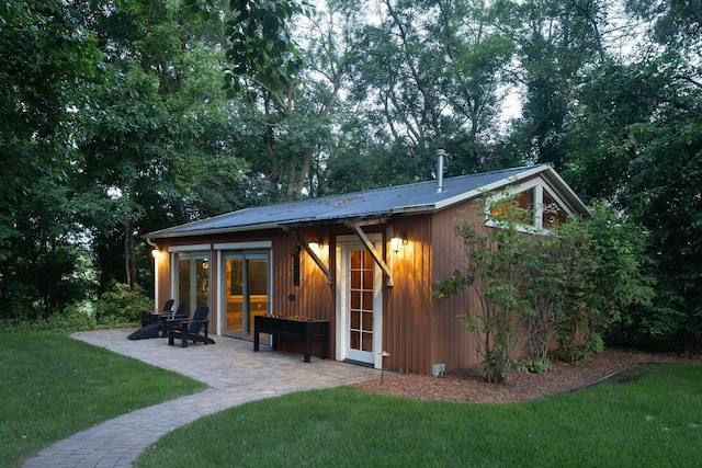 6445 County Road 26, Minnetrista, MN 55364 - back of house featuring a lawn, a patio, and a metal roof