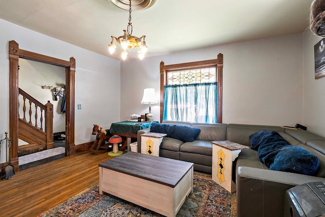 531 2nd St N, Brownton, MN 55312 - living room featuring dark wood-style flooring, a chandelier, and stairs