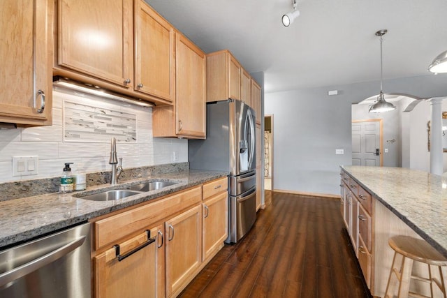 1700 Metro Blvd Unit 210, Edina, MN 55439 - kitchen featuring appliances with stainless steel finishes, light stone countertops, backsplash, dark wood-type flooring, and decorative light fixtures