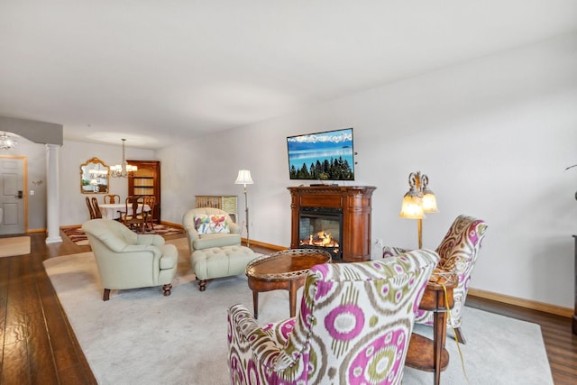 1700 Metro Blvd Unit 210, Edina, MN 55439 - living area with wood finished floors, a chandelier, and a glass covered fireplace