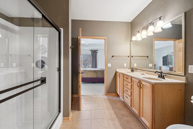 1700 Metro Blvd Unit 210, Edina, MN 55439 - full bath with connected bathroom, double vanity, a stall shower, and tile patterned flooring