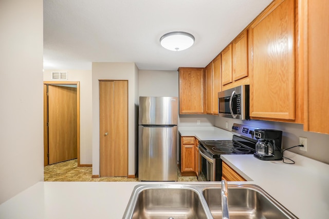 15521 Foghorn Ln, Apple Valley, MN 55124 - kitchen with stainless steel appliances, light countertops, and brown cabinetry