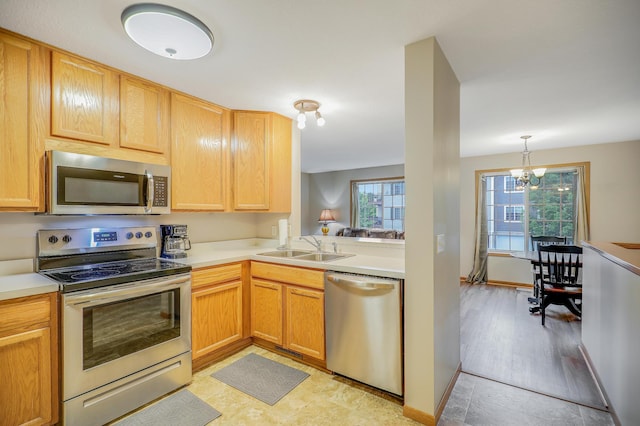 15521 Foghorn Ln, Apple Valley, MN 55124 - kitchen with appliances with stainless steel finishes, a chandelier, light countertops, and decorative light fixtures