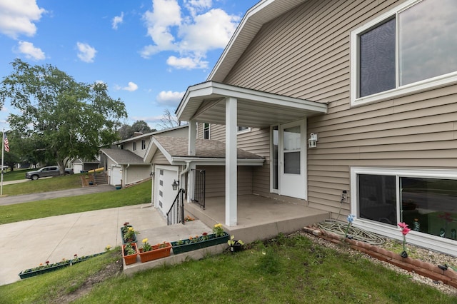 4990 148th Path W, Apple Valley, MN 55124 - property entrance featuring a lawn, driveway, and covered porch